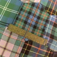 Close-up of high-quality tartan fabric being prepared for kilt alterations in Dunfermline.